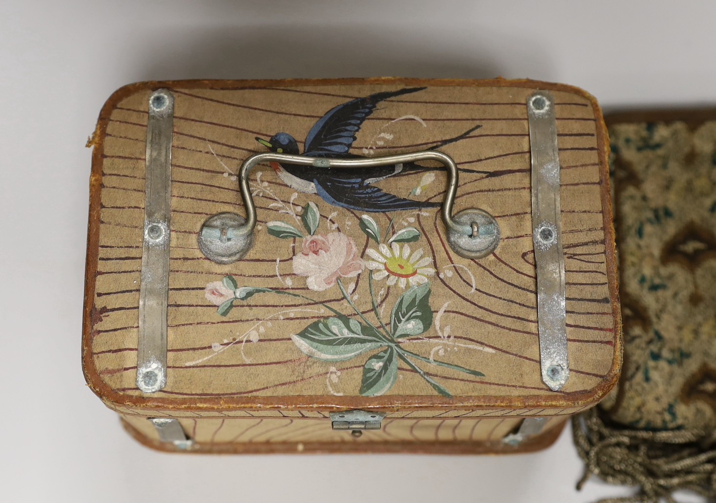 A suitcase containing a collection of late 19th century leather sewing bags and containers, wooden darning mushrooms, etc